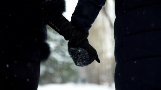 Man-and-Woman-Holding-Hands-in-Winter