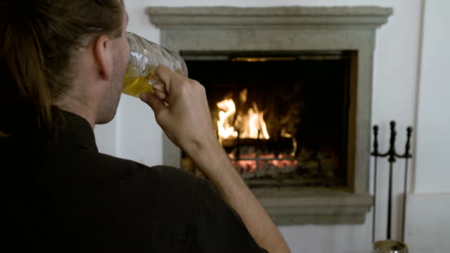 Drinking-beer-in-front-of-the-fireplace