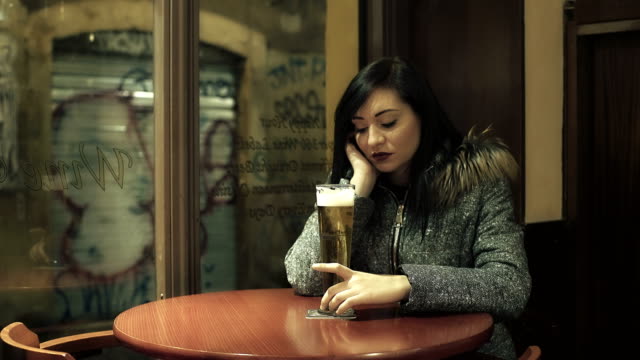depressed-woman-at-the-pub-reflected-in-front-of-a-pint-of-beer