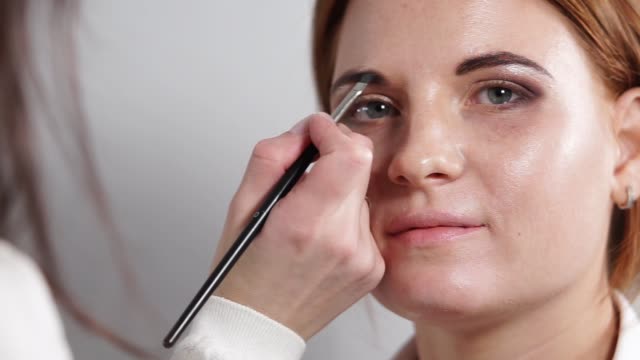 Schuss-von-Makeup-Artist,-einen-Bleistift-benutzt,-um-eine-Augenbraueform-erstellen,-hautnah