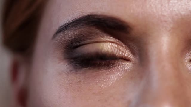 close-up-shot-of-the-gray-blue-eye-of-adult-woman-who-blinks-and-closes-her-eye