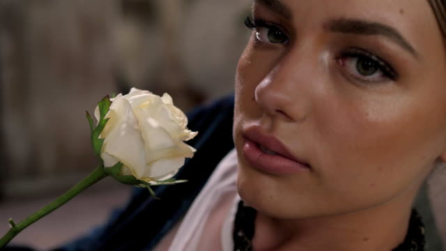 Close-up-shot-of-sexy-woman-lips-with-lipstick-and-beautiful-white-rose-sensual
