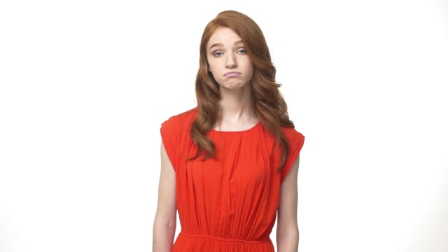 Young-beautiful-caucasian-woman-in-gorgeous-orange-dress-standing-and-say-no-isolated-over-white-background-while-looking-camera.