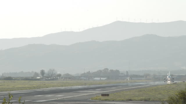 Airplane-taking-off-from-runway-of-airport-at-sunset