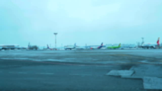 Plane-and-several-cars-moves-across-field-of-the-airport.