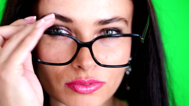 green-background,-chromeakey.-portrait-of-a-sexy-brunette-woman-with-red-lips,-in-stylish-glasses,-spectacles,-eroticly,-playfully-moves,-looking-sexually-at-camera,-posing-in-studio