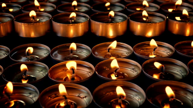 Rows-Of-Candles-Flicker-Moving-Shot