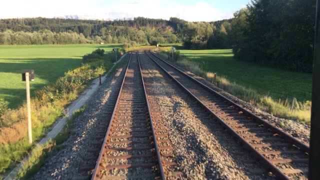 Filming-out-of-back-window-of-driving-train-through-beautiful-German-landscape-in-the-summer