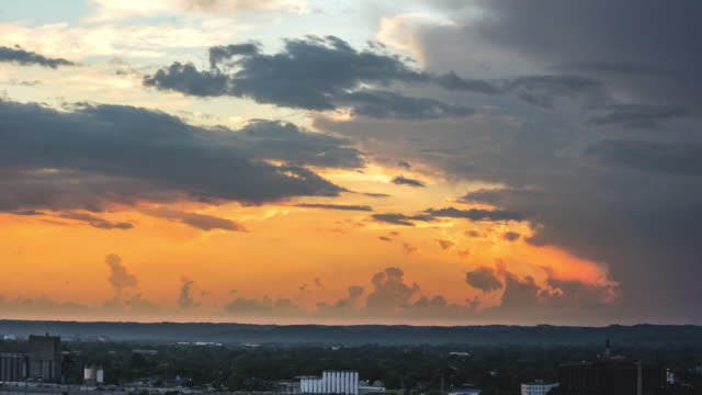 Time-Lapse-of-Clouds-Forming-and-Sun-Dancing-over-Midwestern-City-transition-from-Day-to-Sunset-to-Night