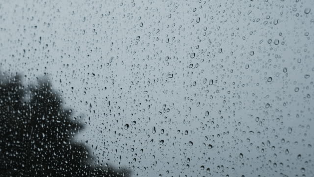 Heavy-rain-against-a-window,-handheld-footage.