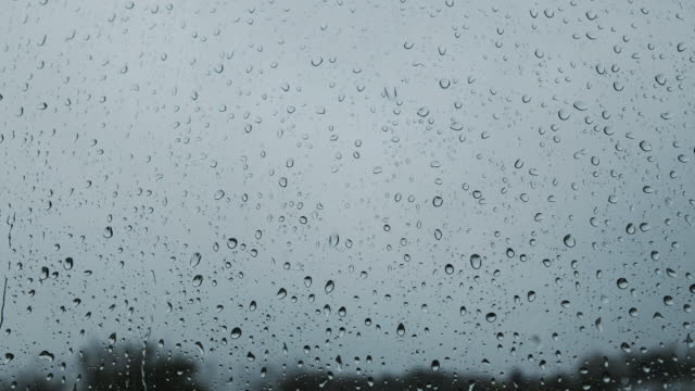 Heavy-rain-against-a-window,-handheld-footage.