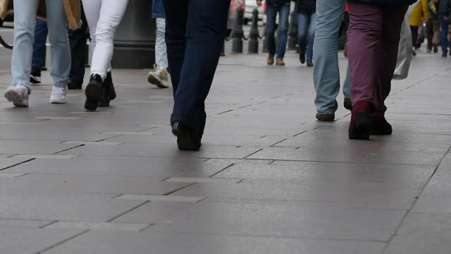 Feet-of-people-walking-on-the-city-street