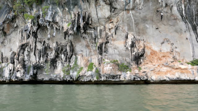 limestone-mountain-cliff-along-coastal-area-in-Phangnga-Bay-national-park,-Thailand-in-summer-for-environment,-relaxation,-travel,-journey,-season-and-climate-change-concept