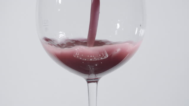 Mauve-Colored-Liquid-Into-Wine-Glass