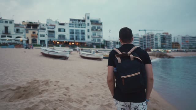 Man-walking-on-beach-alone-in-summer.