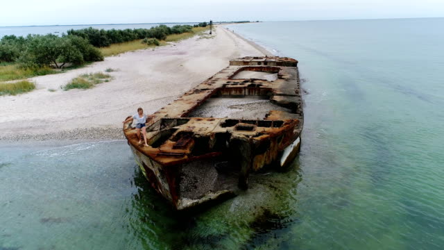 Young-woman-walking-on-a-shipwreck