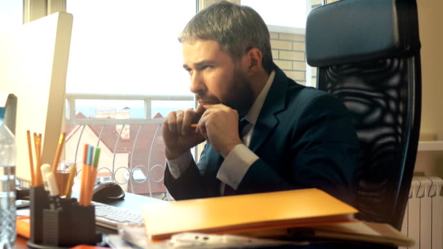 Young-bearded-businessman-getting-angry-and-breaking-the-pencil-after-receiving-an-email.-FullHD-video