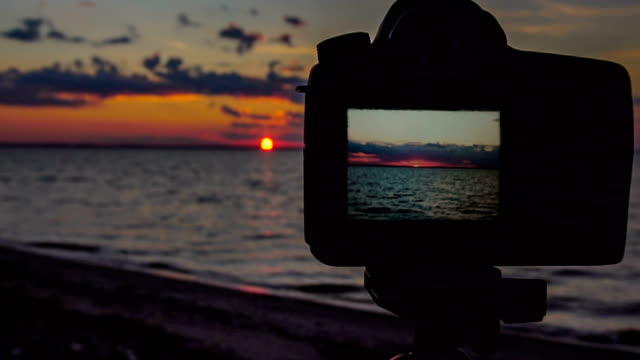 Taking-video-at-sunset-by-the-beach