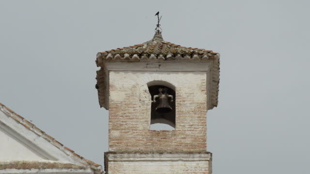 Antique-Christian-church-bell-tower-built-on-an-Arab-minaret-in-Daimalos,-Spain