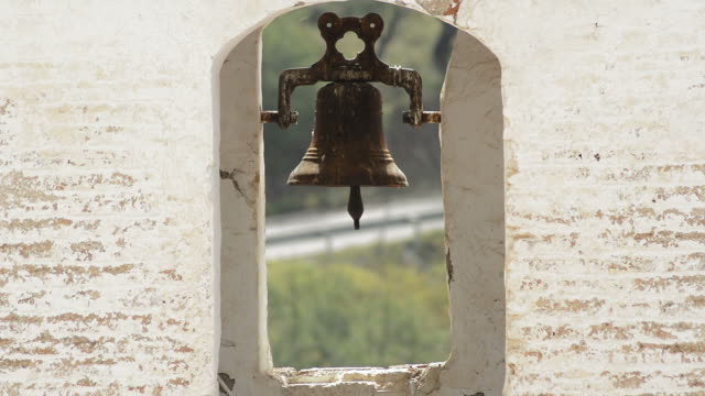 Old-bell-in-a-bell-tower-of-a-antique-christian-church-in-Daimalos,-Spain