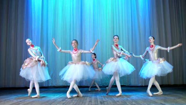 ballet-rehearsal,-on-the-stage-of-the-old-theater-hall.-Young-ballerinas-in-elegant-dresses-and-pointe-shoes,-dance-elegantly-certain-ballet-motions,-pass,-scenic-bow