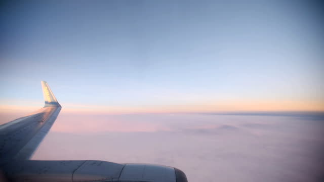 Purple-clouds-seen-through-the-window-of-jet-airplane-at-the-sunset.-HD-video-High-Definition