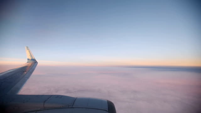 Purple-clouds-seen-through-the-window-of-jet-airplane-at-the-sunset.-HD-video-High-Definition