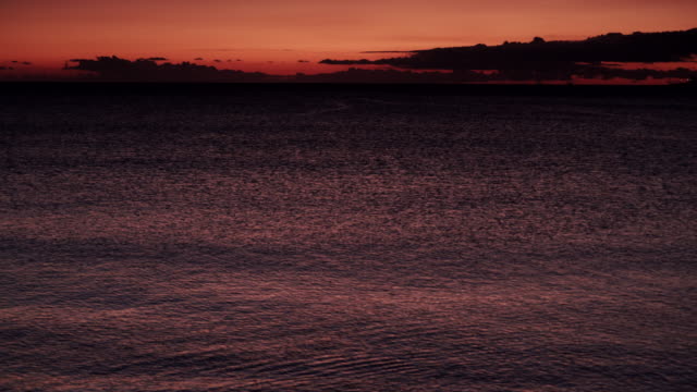 Red-orange-sky-after-sunset-over-sea-surface