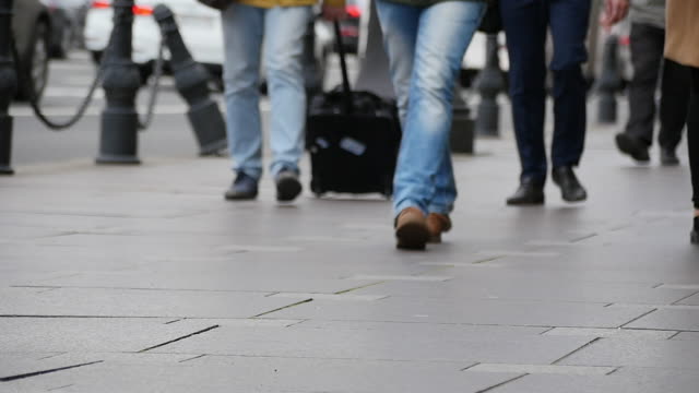 Feet-of-people-walking-on-the-city-street