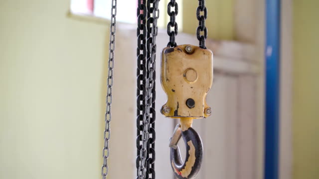 A-rusty-chain-hook-hanging-on-the-industrial-tools