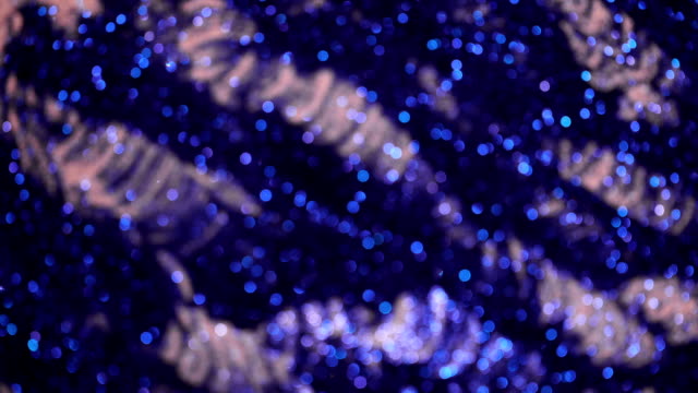 Beautiful-festive-blue-glitter-background-with-flickering-colorful-light-particles.
