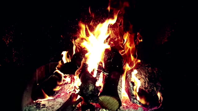 real-fire-flames-burn-movement-with-branches-of-wood,-fireplace-in-slow-motion,-on-black