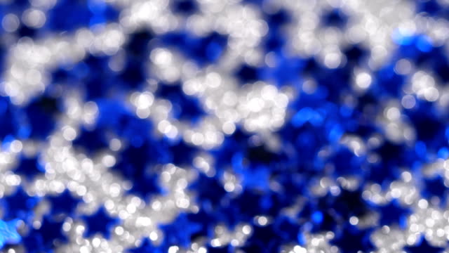 Sparkling-glitter-in-the-shape-of-a-star.-Close-up-on-a-silver-background