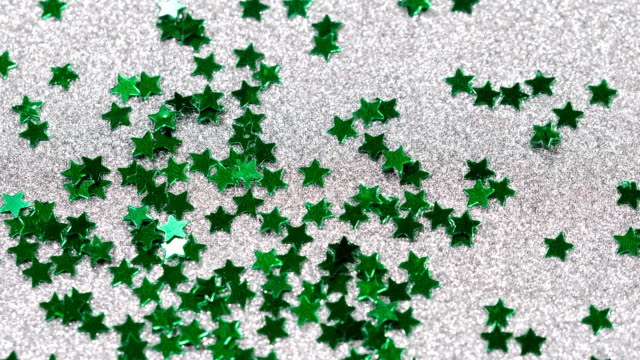 Sparkling-glitter-in-the-shape-of-a-star.-Close-up-on-a-silver-background