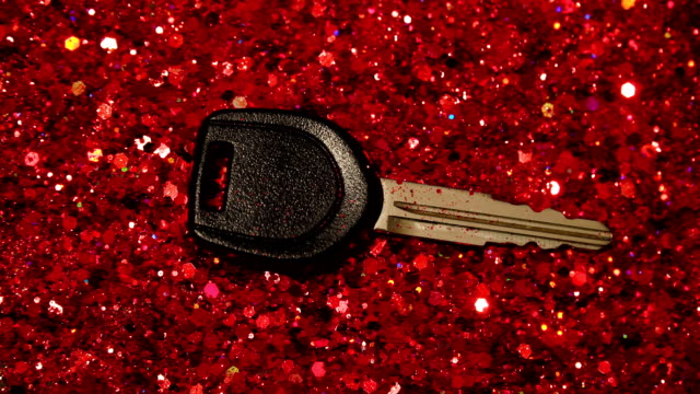 Car-key-against-the-background-of-red-glitter