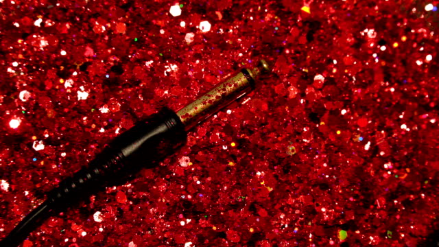 Black-cable-on-the-background-of-red-glitter