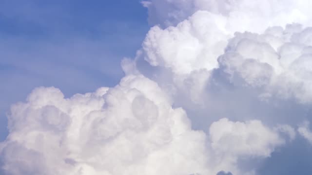 Blue-sky-with-clouds-timelapse.-White-big-cloud-on-blue-sky.-a-big-and-fluffy-cumulonimbus-cloud-in-the-blue-sky.-Edge-of-a-large-white-cloud-timelapse.-panorama.-landscape-blue-sky-moving-timelapse