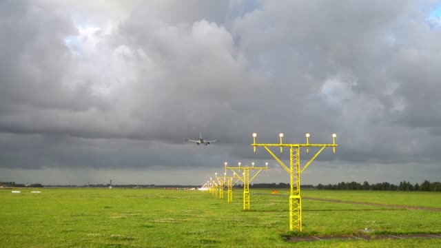 Airplane-landing-at-illuminated-runway