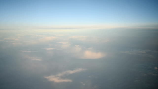 Blue-and-whithe-clouds-seen-through-the-window-of-jet-airplane-in-bright-sunny-day.-HD-video-High-Definition