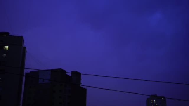 Lightning-in-the-night-sky-in-the-city,-a-bright-flash-of-light-in-the-clouds-in-the-rain,-a-thunderstorm