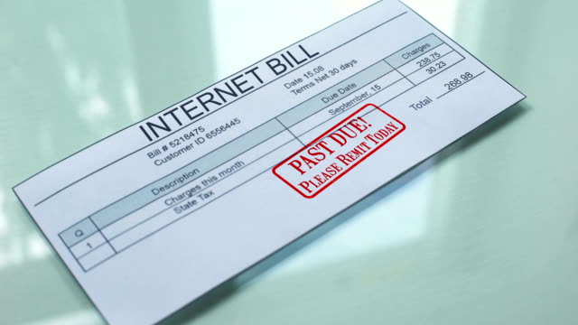 Past-due-internet-bill,-hand-stamping-seal-on-document,-payment-for-services