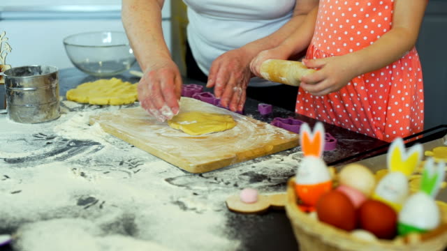 Little-Girl-and-Grandma-Rolling-Out-a-Dough