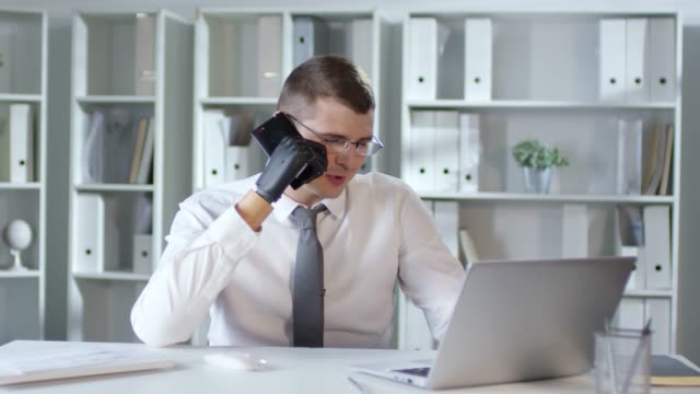 Businessman-with-Prosthetic-Hand-Calling-on-Phone