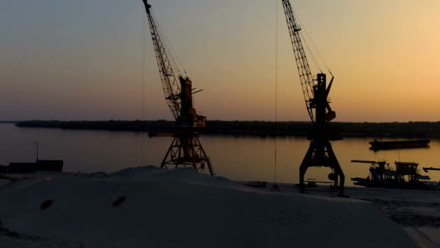 old-river-port-with-port-cranes.-sunset