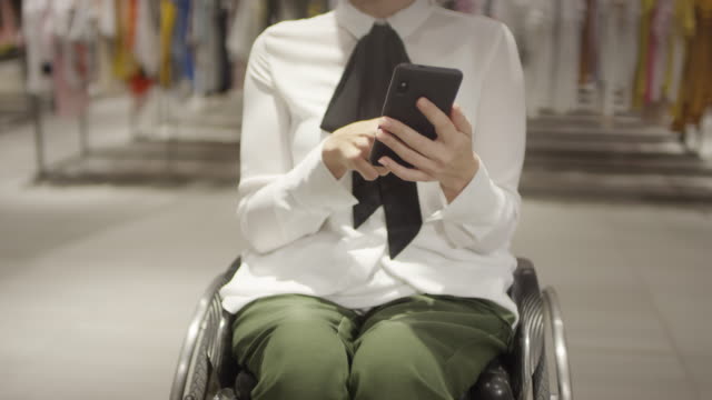 Unrecognizable-Woman-in-Wheelchair-Browsing-Internet-on-Phon