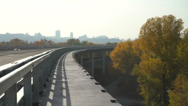 Unfinished-bridge-against-the-background-of-the-silhouette-of-the-city.-Unfinished-highway-away-city