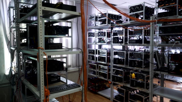 Cryptocurrency-equipment,-mining-money-electronic-farm,-finance-concept.-Stock-footage.-Bitcoin-farm-with-working-computer-equipment