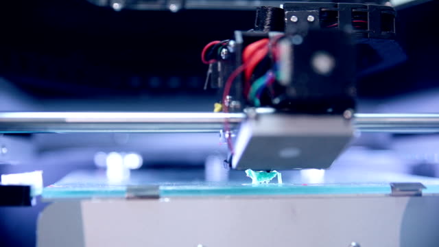 3d-printer-works,-making-figure-of-human-from-plastic