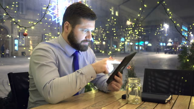 Businessman-browsing-tablet,-look-at-camera,-evening,-cafe,-portrait