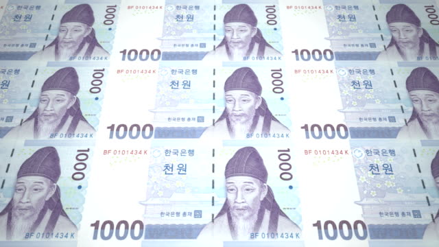 Billetes-de-mil-wons-de-Corea-del-Sur-rodando,-dinero-en-efectivo,-bucle